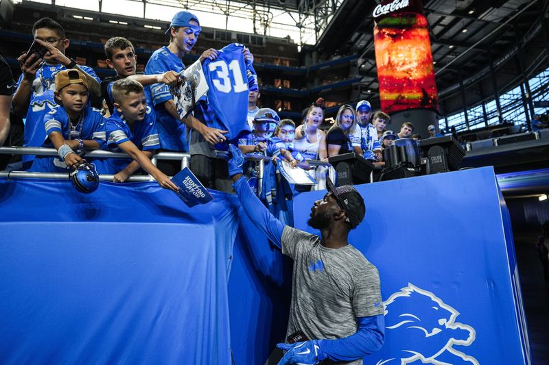 Detroit Lions safety Kerby Joseph (31) signs autographs for fans during warm up ahead of the Cleveland Browns game at Ford Field in Detroit on Sunday, Sept. 28, 2025.