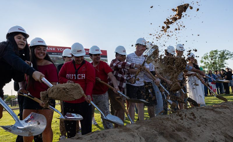 Holland High School students help break ground on the school's new stadium during a ceremony on Monday, June 1.