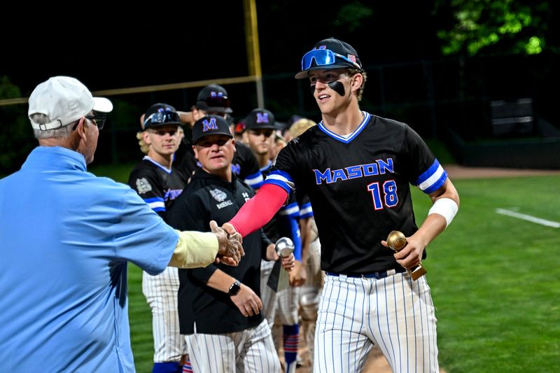 Mason's Gerrit Koot accepts the tournament MVP trophy from legendary coach Pat O'Keefe after the Bulldogs win over Lansing Catholic in the Diamond Classic on Monday, June 1, 2026, at McLane Stadium in East Lansing.