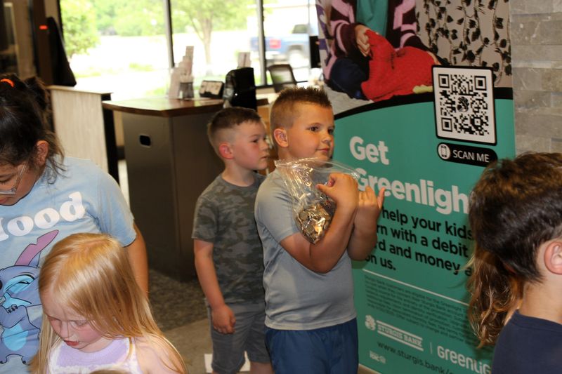Beau Watson and several students from Wall School were at Sturgis Bank & Trust to have their money counted from this year's coin drive.