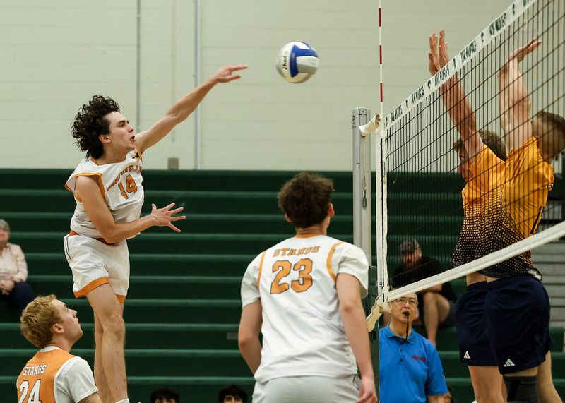 Northville's Julian Janisse spikes during the Division 1 boys volleyball quarterfinal on Tuesday, June 2, 2026, at Novi High School.