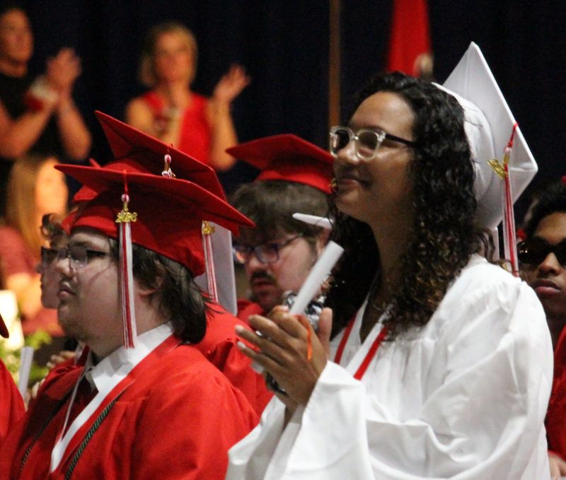 A Port Huron High School graduate applauds during the school's 158th commencement ceremony at McMorran Place in Port Huron on June 2, 2026.