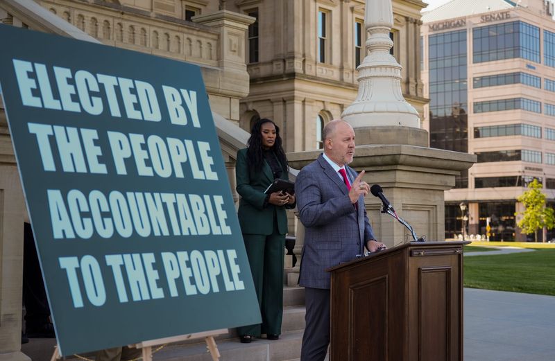 Michigan State University trustee Mike Balow, right, speaks Wednesday, June 3, 2026, during a joint press conference with fellow board member Rema Vassar, left at the state Capitol in Lansing. The two defended their refusal to sign MSU's updated code of conduct agreement for board members.