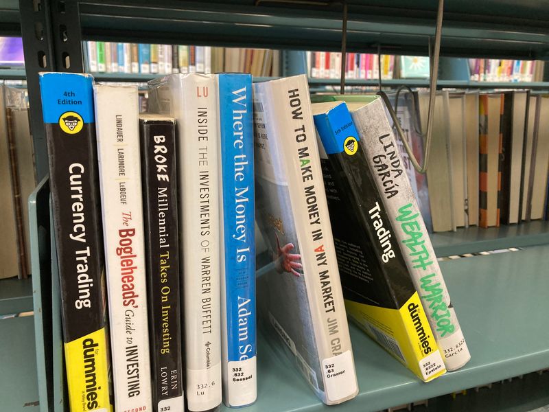 Books on investing on the shelves of the Lansing Public Library on June 3, 2026.