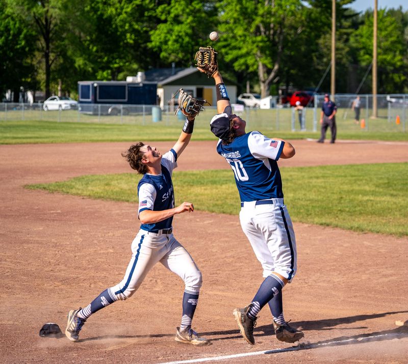 St. Mary's Eli Switalski (left) and Charlie Cameron (right) both camp under a pop-up during a regional semifinal loss to Mio on Wednesday, June 3 in Bellaire, Mich.