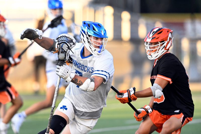 Detroit Catholic Central attacker Blake Papke, left, tries to get around a Birmingham Brother Rice defenseman during the fourth quarter of an MHSAA Division 1 boys lacrosse semifinal, Wednesday, June 3, 2026, at Seaholm HS in Birmingham, Mich. Catholic Central defeated Brother Rice 13-7. (Jose Juarez/Special to Detroit News)