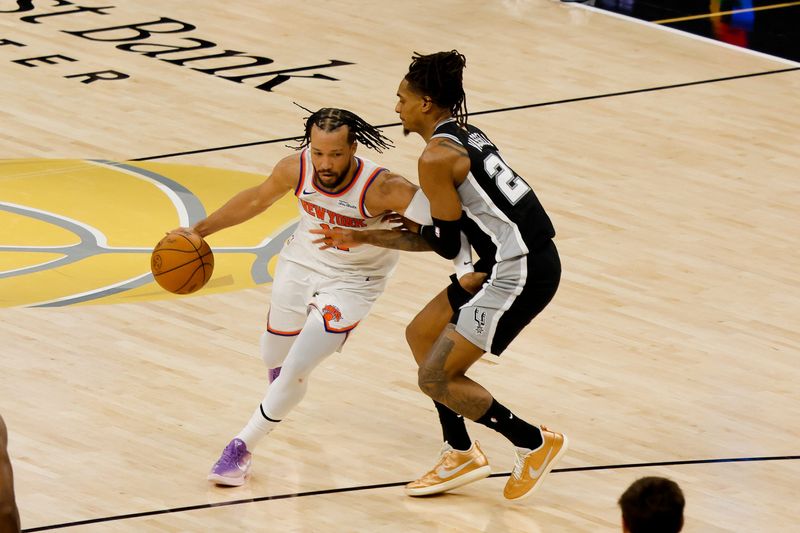 New York Knicks guard Jalen Brunson moves the ball past San Antonio Spurs guard Devin Vassell during the second quarter during Game 1 of the 2026 NBA Finals at Frost Bank Center, June 3, 2026.