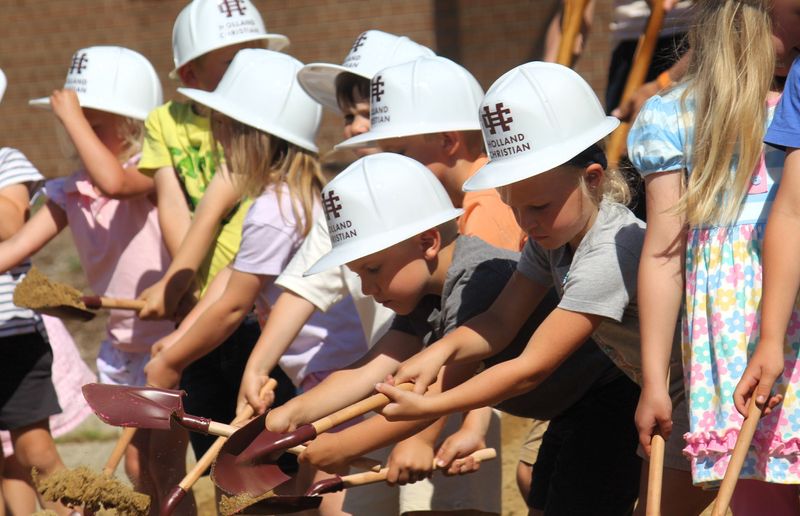 South Side Elementary students dig into a pile of dirt during a groundbreaking ceremony June 3.