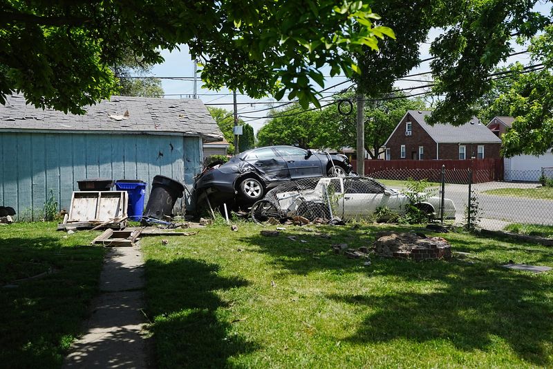 A vehicle crashed through a fence and landed on top of DJ Matkins 1987 Oldsmobile Cutlass, impaling the driving, who was reportedly being chased by authorities, on Warwick avenue in Detroit on Thursday, June 4, 2026.