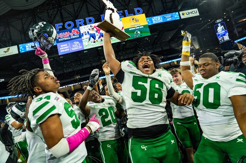 Detroit Cass Techâ€™s Antijuan Wilkes Jr., Marvin McCallum, Logan Howell, and Jestin Wilson celebrate their win against Hudsonville, at the end of the MHSAA Division 1 football finals at Ford Field in Detroit on Saturday, Nov. 30, 2024.