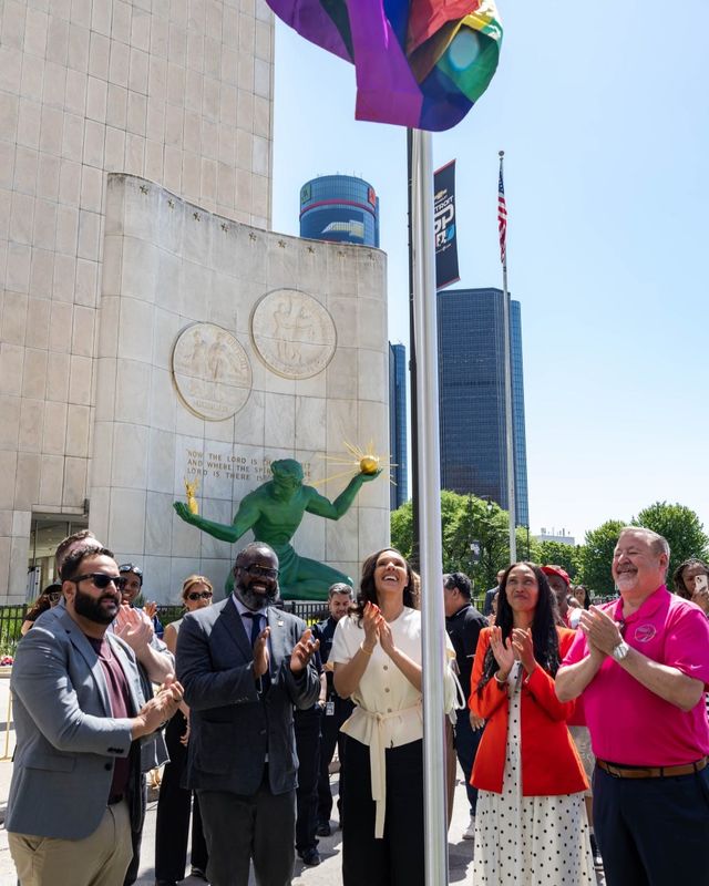 Detroit Mayor Mary Sheffield, in white, and Detroit City Councilman Denzel McCampbell, to Sheffield's right, join city officials and Motor City Pride festival organizers in raising the Pride flag at downtown Detroit's Spirit Plaza on Wednesday, June 3, 2026.