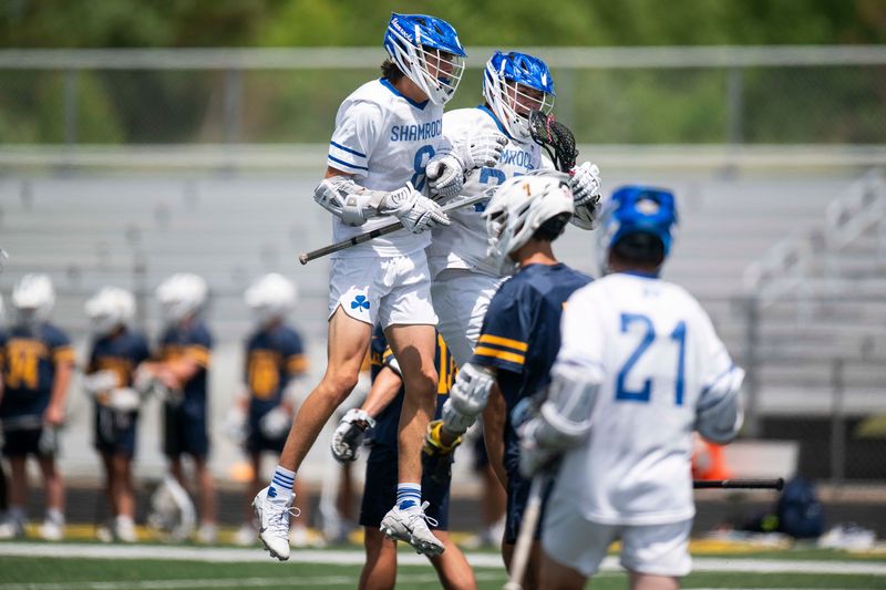 Detroit Catholic Central's Asher Miscovich, left, celebrates with a teammate after scoring a goal against Hudsonville in the Division 1 boys lacrosse state final.