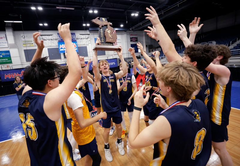 Grand Haven players celebrate with their trophy after defeating Lake Orion in their MHSAA Division 1 championship match.