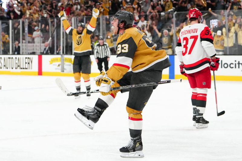 Vegas Golden Knights right wing Mitch Marner (93) celebrates after a goal by defenseman Shea Theodore (not pictured) as Carolina Hurricanes right wing Andrei Svechnikov (37) reacts during the second overtime.