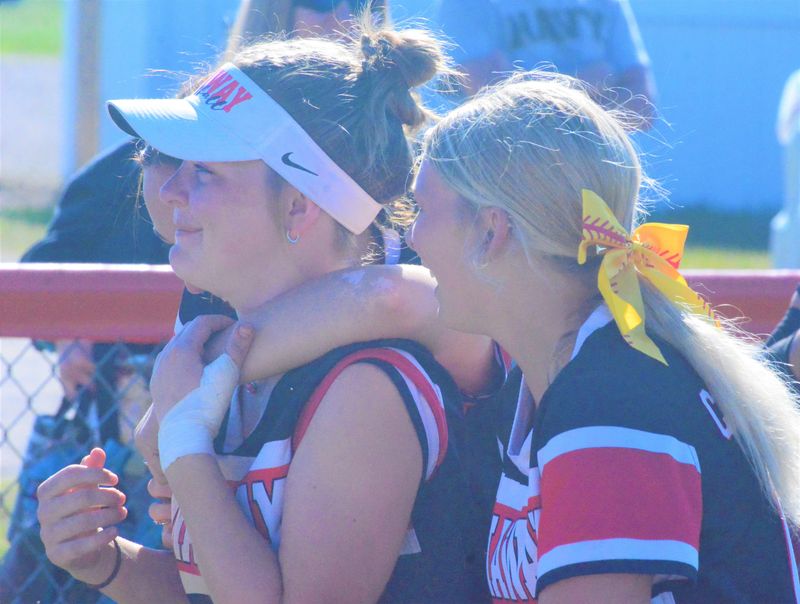 Onaway players show their love for senior Carley Karsten (left), who played her final game for the Cardinals in an MHSAA Division 4 softball regional final against Hillman in Rogers City on Saturday, June 6.