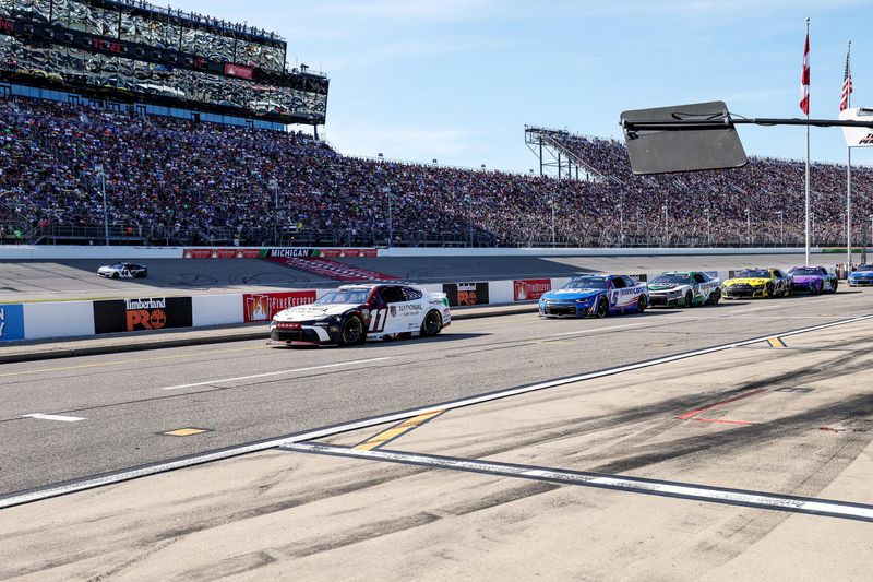 NASCAR Cup Series drivers Denny Hamlin (11), Kyle Larson (5), Daniel Suárez (7), and Carson Hocevar (77) make a pit stop during stage three of the FireKeepers Casino 400 NASCAR Cup Series race at Michigan International Speedway in Brooklyn, Michigan, on Sunday, June 7, 2026.