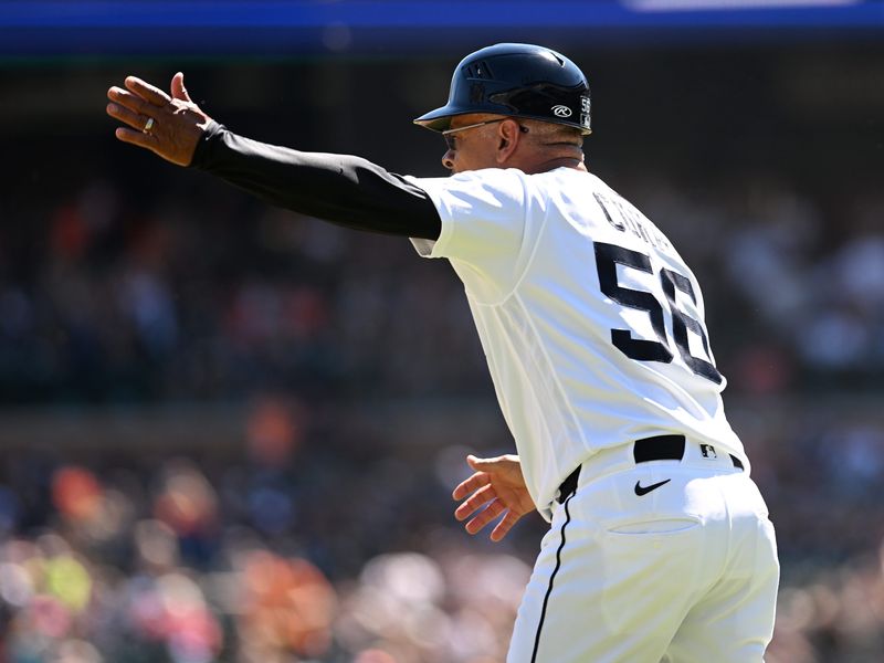 Tigers third base coach Joey Cora (56) waves Zach McKinstry (not shown) home to score in the seventh inning. Detroit Tigers take on the Seattle Mariners on June 7, 2026 at Comerica Park in Detroit.
