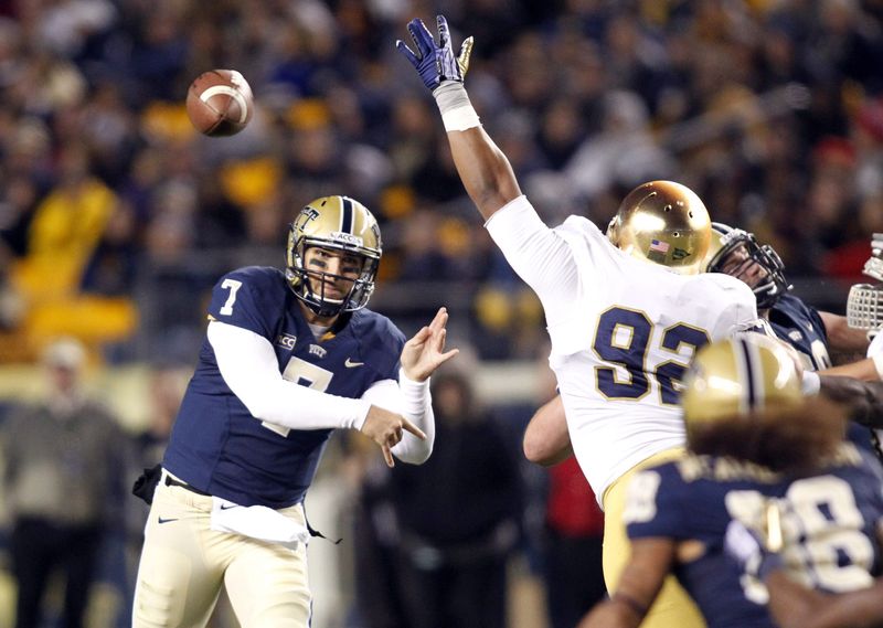 Nov 9, 2013; Pittsburgh, PA, USA; Pittsburgh Panthers quarterback Tom Savage (7) passes the ball against pressure from Notre Dame Fighting Irish defensive lineman Tyler Stockton (92) during the second quarter at Heinz Field. Mandatory Credit: Charles LeClaire-USA TODAY Sports