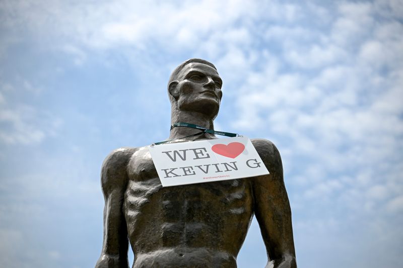 A sign supporting outgoing Michigan State University President Kevin Guskiewicz hangs around the neck of the Sparty Statue on Monday, June 8, 2026, in East Lansing.