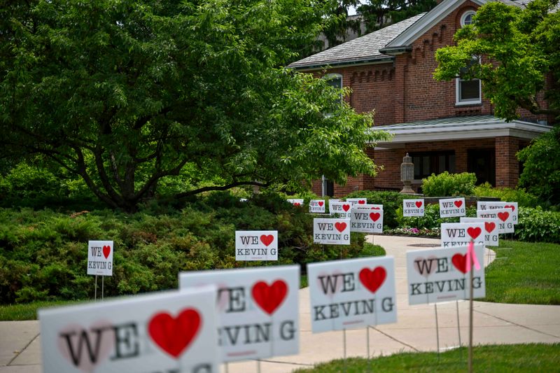 Dozens of signs supporting Michigan State University President Kevin Guskiewicz are placed outside Cowles House on Monday, June 8, 2026, in East Lansing.
