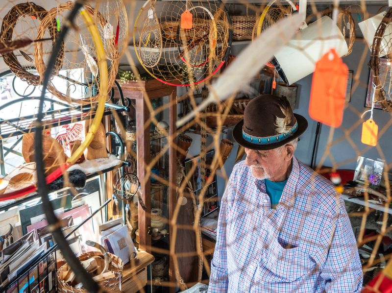 Ron Paquin stands beneath a dream catcher inside his little shop next to his home in St. Ignace on Sunday, April 19, 2026.
