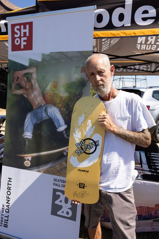 Michigan native Bill Danforth, who grew up in Gross Pointe, holds one of his professional skateboard decks outside the Modern Skate and Surf booth at the Creative Grind Festival at Eckstein Skate Park in Warren on June 13, 2026. Danforth was also recently inducted into the Skateboarding Hall of Fame.