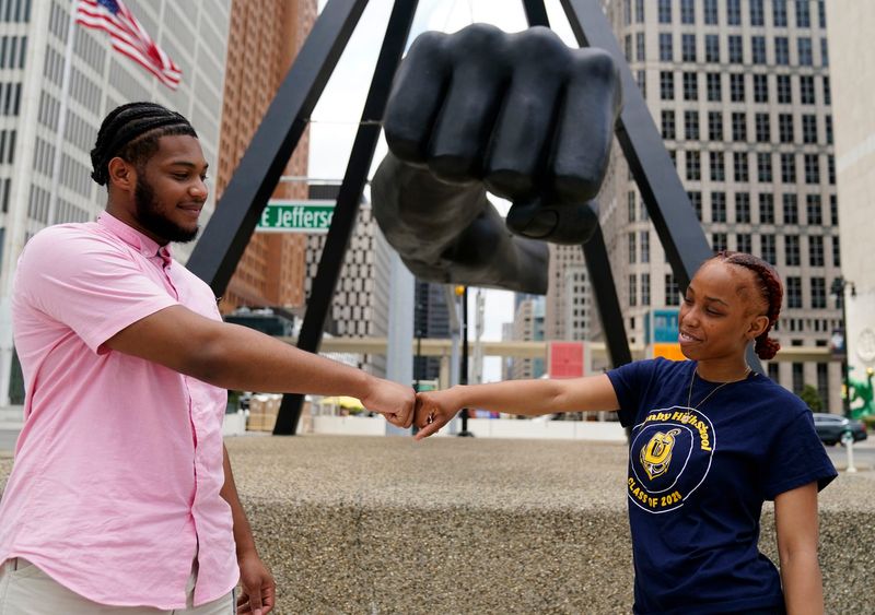 Melvin Alston, 20, of Detroit, a special projects fellow and “Out of School Time” fellow for the city of Detroit, left, poses with a fist bump at the monument to Joe Louis “The Fist” with cabinet member for the city of Detroit Danasha’ Tidwell, 16, of Detroit, on Wednesday, June 10, 2026.