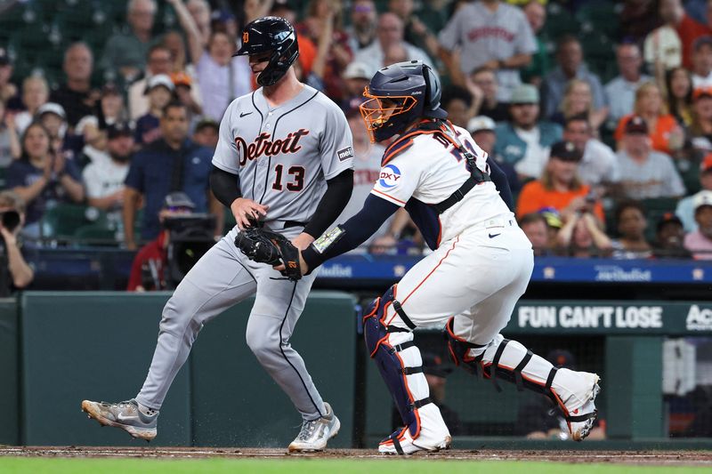 Jun 16, 2026; Houston, Texas, USA; Houston Astros catcher Yainer Diaz (21) tags out Detroit Tigers catcher Dillon Dingler (13) on a play at the plate during the first inning at Daikin Park. Mandatory Credit: Troy Taormina-Imagn Images