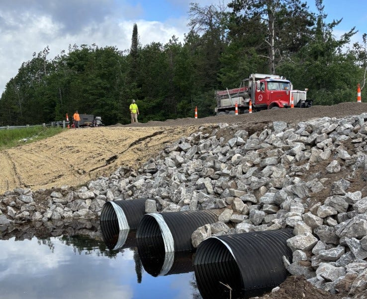 A Michigan Department of Transportation construction team repairs a washed-out culvert on M-68 east of Ocqueoc Falls in Presque Isle County. The area was one of scores of areas throughout northern Michigan that flooded due to a snowpack that melted at the same time rain poured on the northern part of the state.