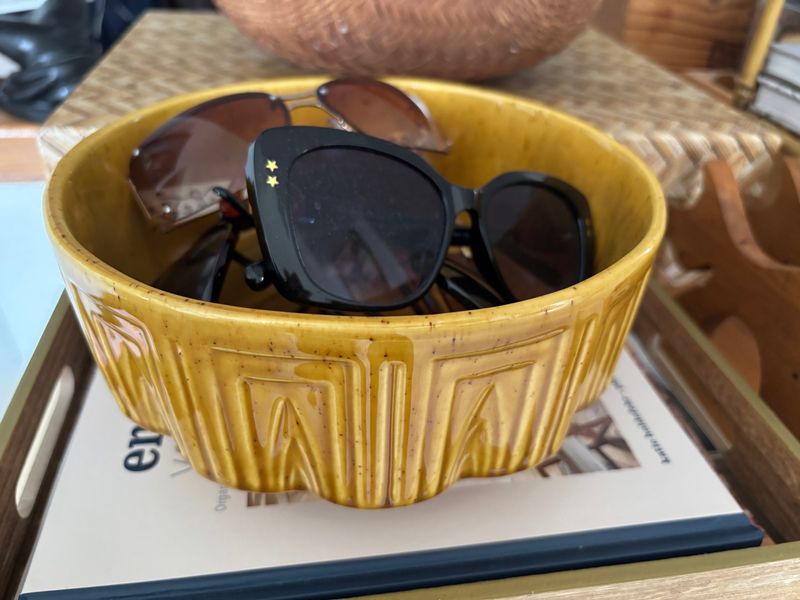 Sunglasses can be stashed in a colorful bowl that serves as a display and a reminder to grab them on your way out the door.