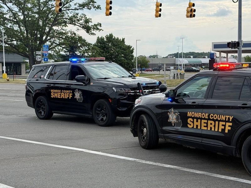 Monroe County Sheriff's Office vehicles block the intersection.