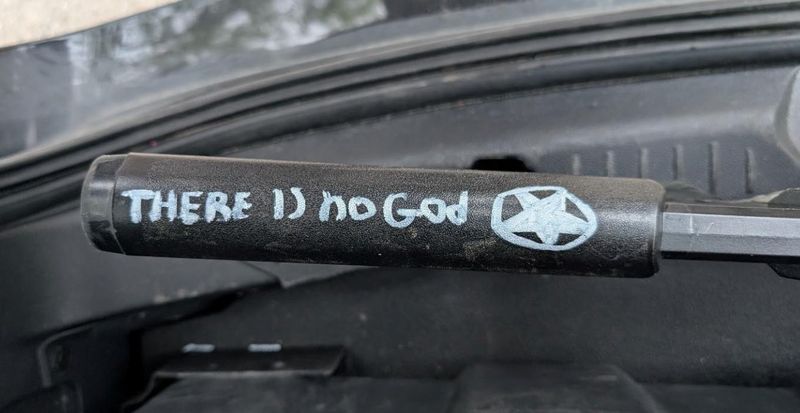FBI investigators say a rifle seized from Eleazareli Maycock contained the phrase "There is no God" written in white paint marker on the stock.