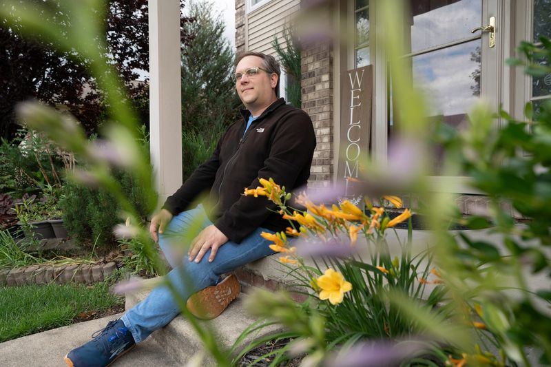 Michael Mazur, 38, of Sterling Heights,  sits outside of his recently purchased first home in Sterling Heights that he hasn’t occupied yet on Thursday, June 18, 2026, after several months of searching and submitting multiple offers.