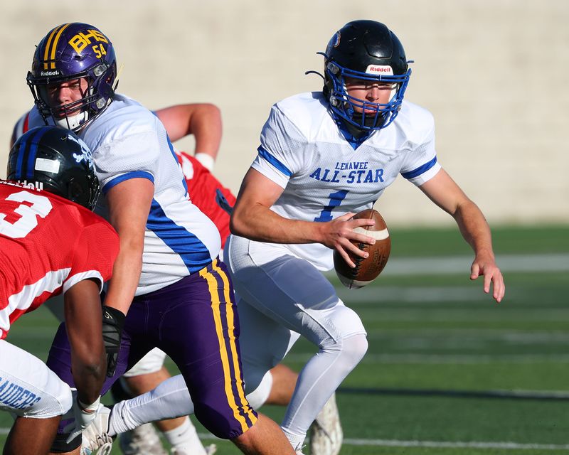 Brian Dopp of Adrian Madison eludes the rush during the Monroe County vs. Lenawee County All-Star Football game at Adrian College on Friday, June 19, 2026.