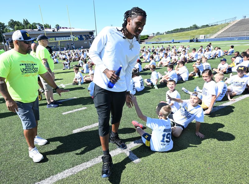 Michigan quarterback Bryce Underwood says hello to campers at Bryce Underwood's Youth Football Camp at Saline High School in Saline, Michigan on July 20, 2026.