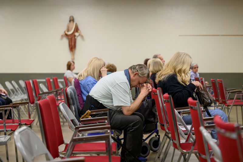 Daniel Lempicki, of Westland, prays before the start of Sunday mass at St. Mary Cause of Our Joy church, in Westland, June 21, 2026.