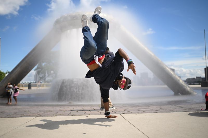 Chris “Detroit Ninja” Jenkins dances in front of the Hart Plaza fountain in Detroit while waiting for the fireworks to begin, June 22, 2026.