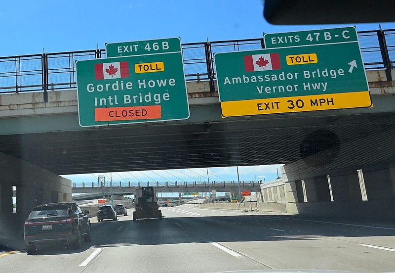 Signage along I-75 for the presently closed Gordie Howe Intl Bridge and the Ambassador Bridge in Detroit, Michigan on June 23, 2026.