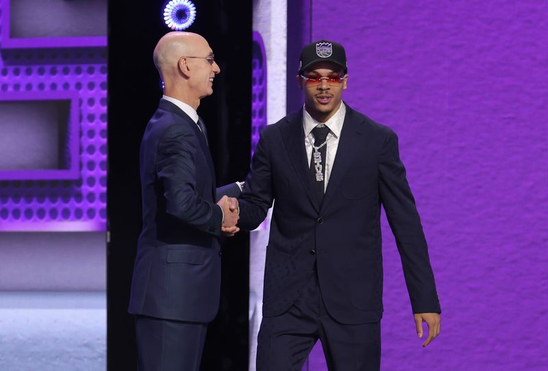NBA commissioner Adam Silver greets the seventh pick in the 2026 NBA draft, Arkansas guard Darius Acuff Jr. after he was selected by the Sacramento Kings at Barclays Center.