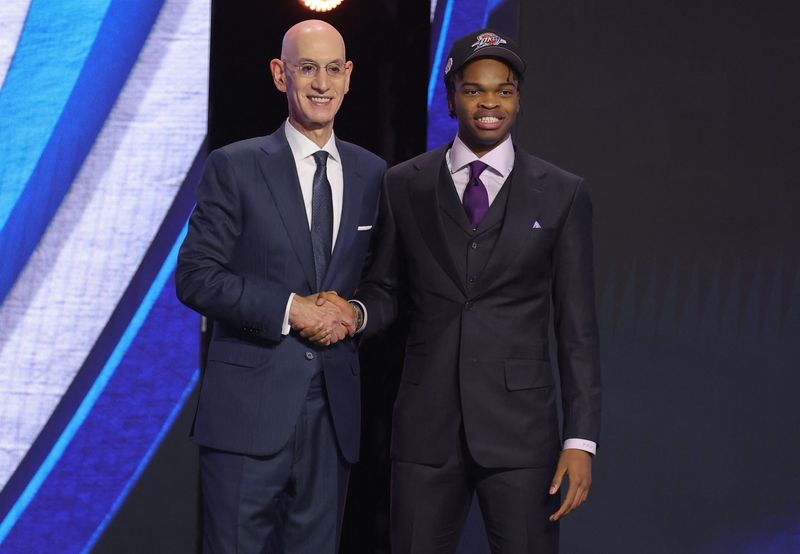 NBA commissioner Adam Silver greets the seventeenth pick in the 2026 NBA draft, Stanford guard Ebuka Okorie after he was selected by the Detroit Pistons at Barclays Center.