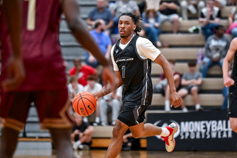 Team Motorcars and Michigan State's Carlos Medlock Jr. moves the ball against Team Faygo during the Moneyball Pro-Am on Tuesday, June 23, 2026, at Holt High School.