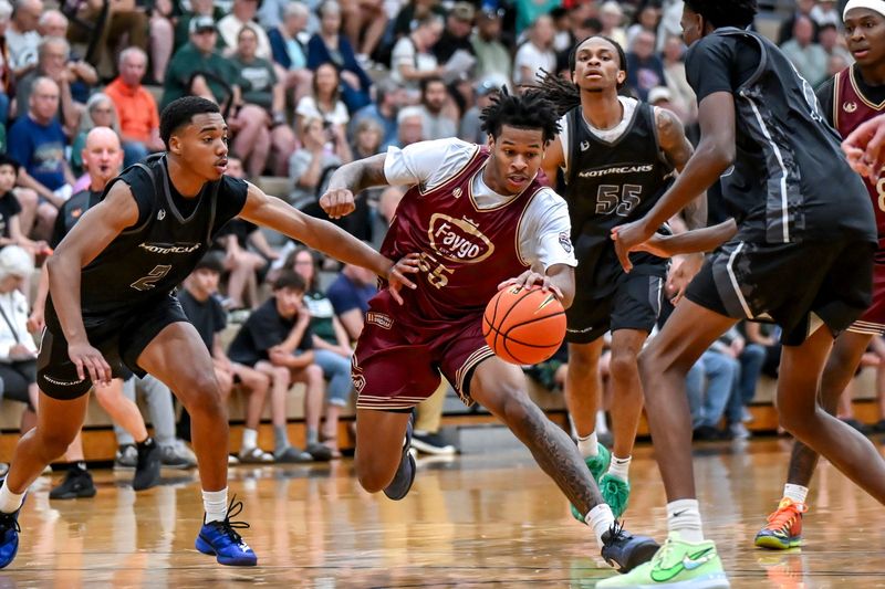 Team Faygo and Michigan State's Jasiah Jervis, center, moves through the Team Motorcars defense during the Moneyball Pro-Am on Tuesday, June 23, 2026, at Holt High School.