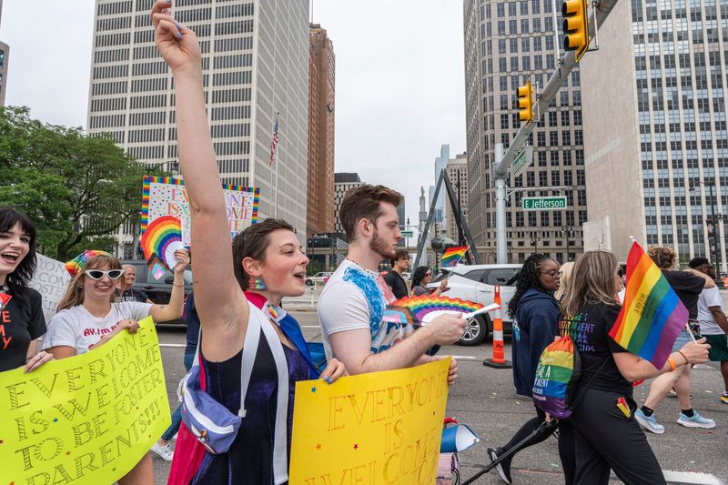 Parade participants wave during the 2025 Motor City Pride Parade in Downtown Detroit, Michigan on Sunday, June 8, 2025.