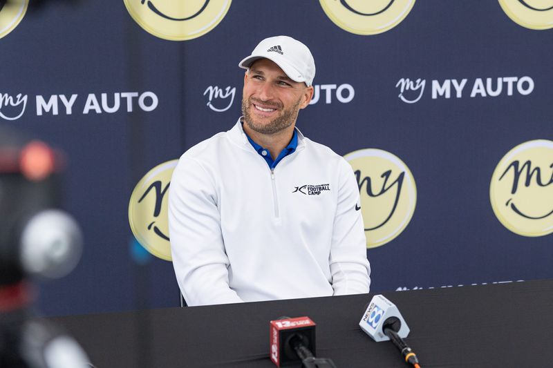Kirk Cousins smiles while answering questions from reporters during the Kirk Cousins Football Camp on Wednesday, June 24.