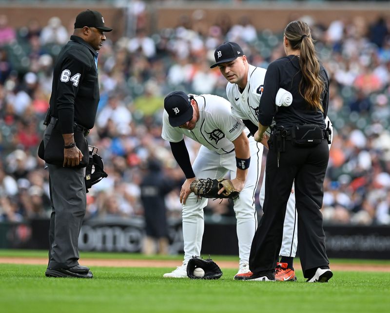Tigers  manager AJ Hinch, left, and assistant athletic trainer Kelly Rhoades, right, check on pitcher Tarik Skubal  in the third inning. Detroit Tigers take on the New York Yankees on June 24, 2026 at Comerica Park in Detroit.