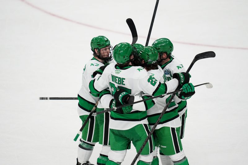Apr 9, 2026; Las Vegas, Nevada, UNITED STATES; North Dakota Fighting Hawks celebrate a goal by forward Ellis Rickwood (29) in the third period against the Wisconsin Badgers in the semifinals of the NCAA men's ice hockey Frozen Four at T-Mobile Arena. Mandatory Credit: Lucas Peltier-Imagn Images