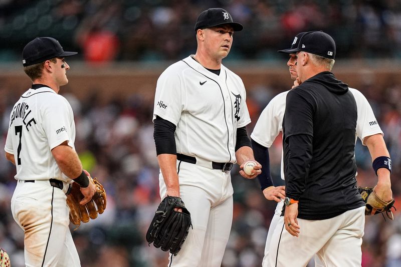 Detroit Tigers pitcher Tarik Skubal (29) talks to manager A.J. Hinch (14) at a mound visit during the sixth inning at Comerica Park in Detroit on Wednesday, June 24, 2026.
