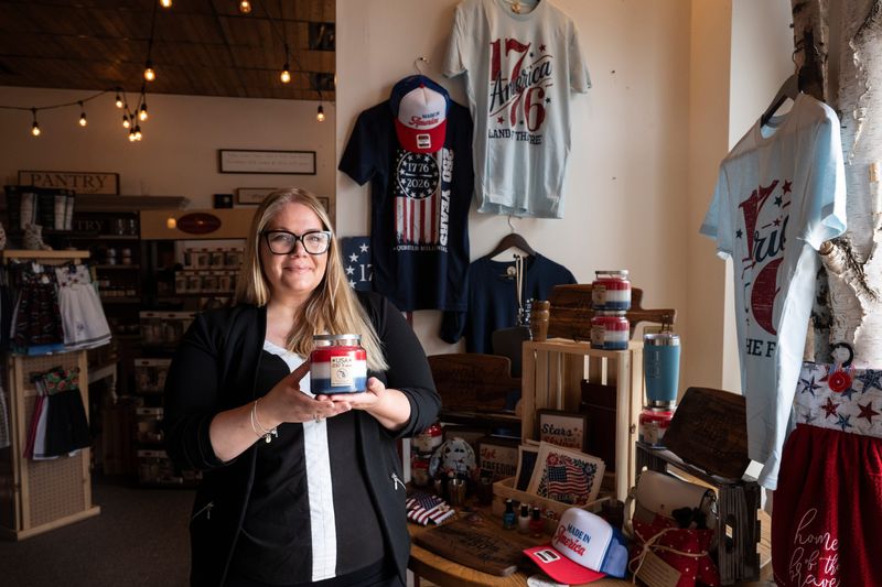Lindsay Wood is selling triple-layer candles in patriotic colors at her store, Kymora Kandles in St. Johns, ahead of America's 250th birthday.