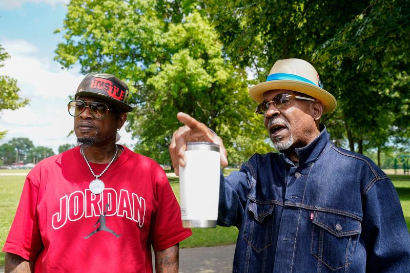 Darron White, 60, of Detroit, left, stands with his friend Juan Bowman, 62, of Canton on Monday, June 22, 2026 in Rouge Park. The two discuss with the Free Press about what a recreation center would mean for residents around Rouge Park.