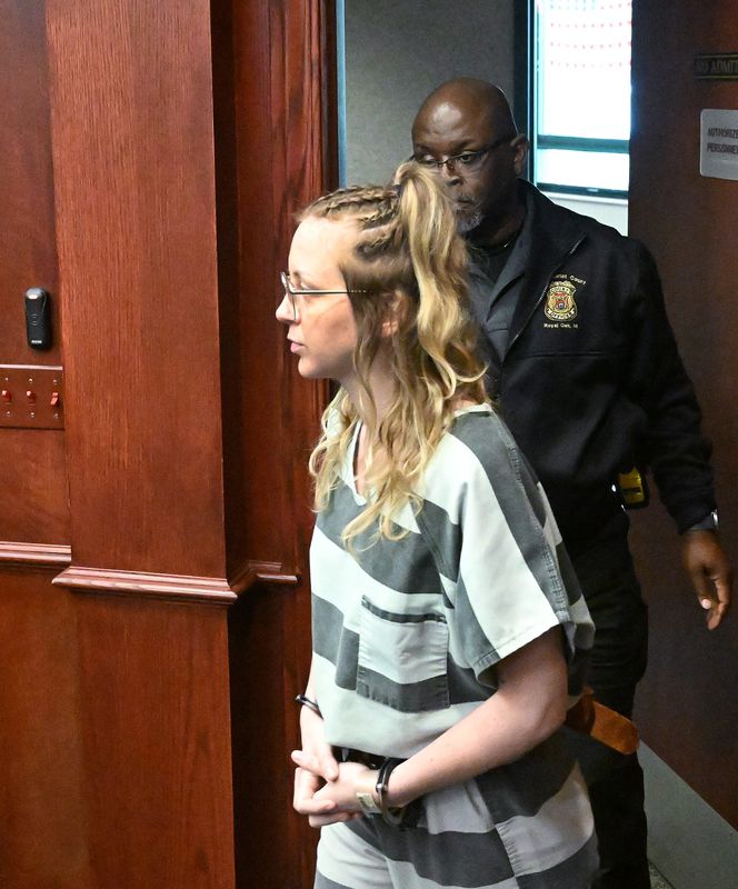Samantha Booth enters the courtroom of 44th District Judge Andrew Kowalski for a preliminary examination in the killing of 83-year-old David Ong of Royal Oak.